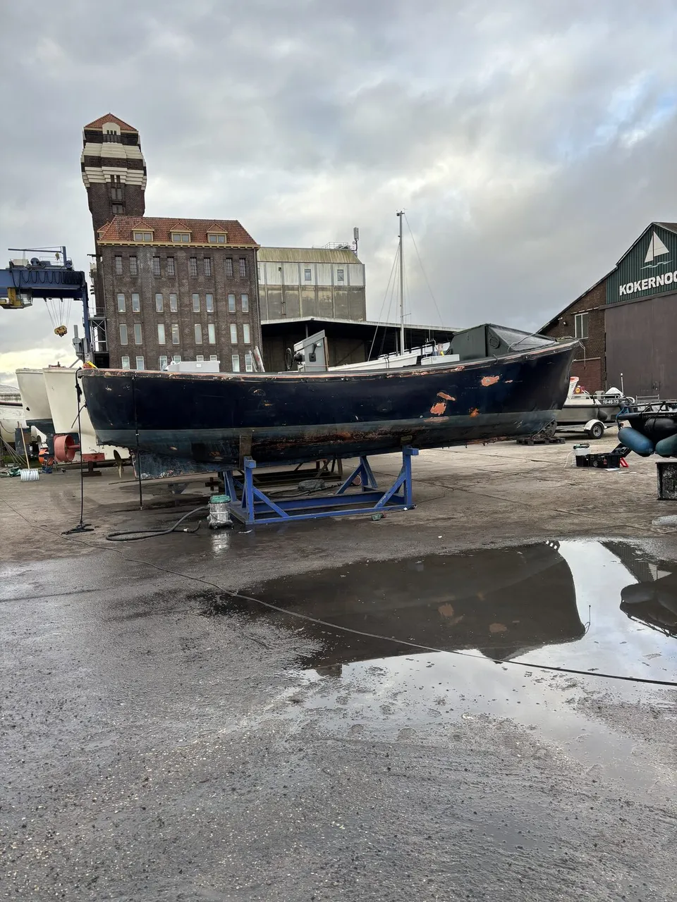 AFTER — the same sloop seen across the yard, Kokernoot in the background