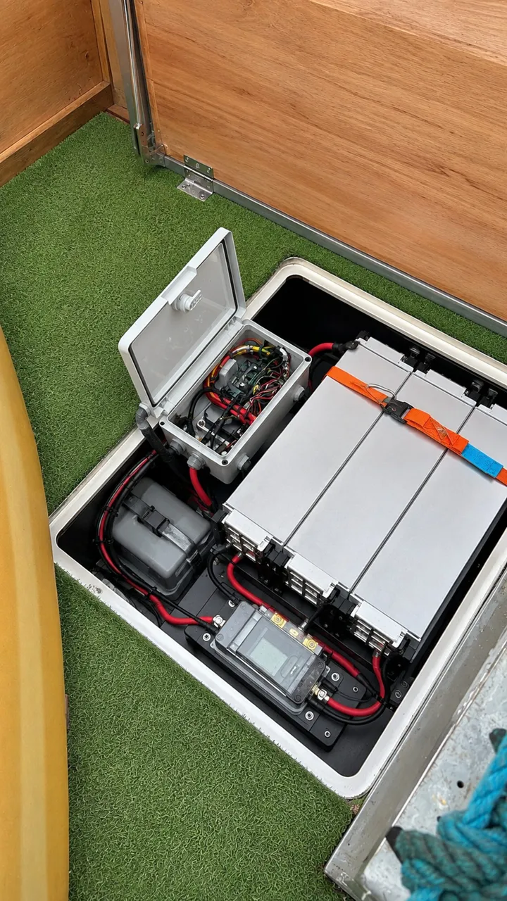 Voltron Marine battery hatch with three IP-rated NMC Lipo modules with orange retention straps, BMS, shunt and main disconnect.